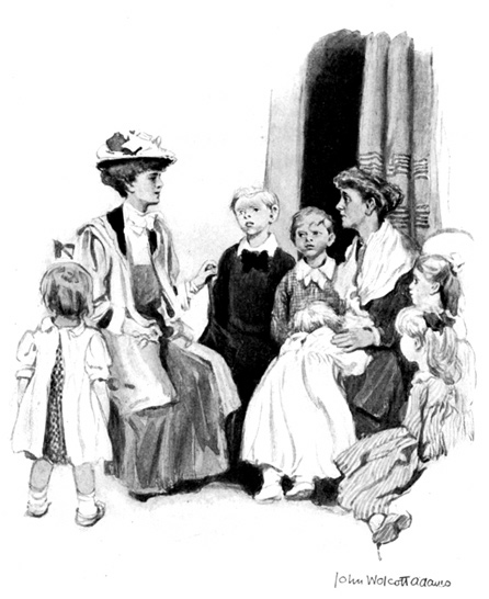 A woman sits surrounded by 6 small children, while another woman looks on.