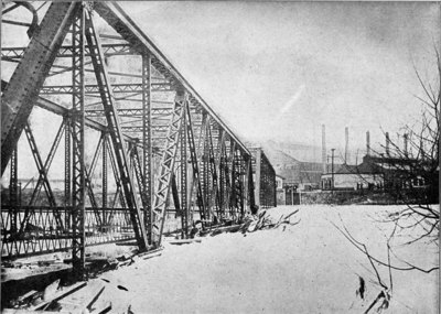 The bridge shown in the illustration leads to the Carnegie Steel Company at Youngstown, Ohio. Ordinarily this bridge is far enough above the water to allow the large river steamers to pass under