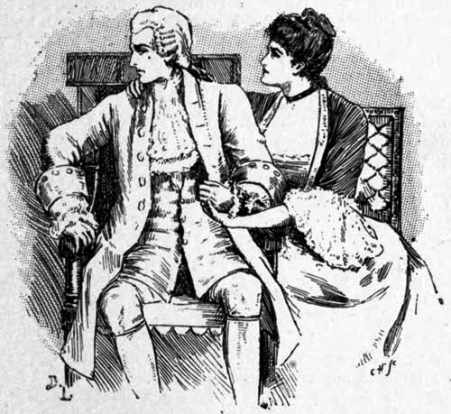 A woman touching and speaking to a seated man.
