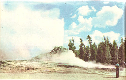 Castle Geyser erupts from an imposing crater