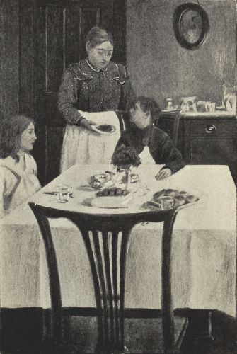 Mrs. Hanlon standing by the two children seated at the table