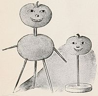 toothpick dolls: tomato body and head on taller one with face on top tomato; smaller one has just a head