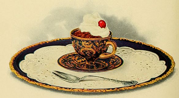 cocoa in beacutiful tea cup topped with whipped cream and a cherry spoon on the side