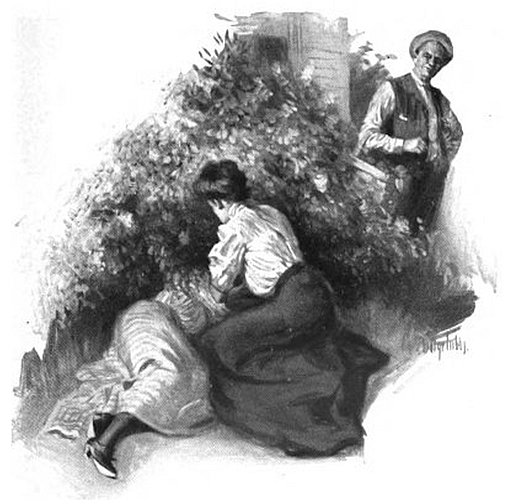 woman kneeling by woman under bush; someone in background watching