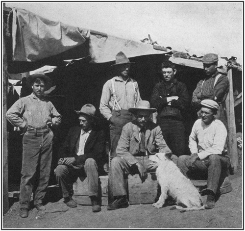 Fig. 43.: American Museum party at Bone-Cabin Quarry,
1899. Seated, left to right Walter Granger, Professor H.F. Osborn, Dr.
W.D. Matthew; standing, F. Schneider, Prof. R.S. Lull, Albert Thomson,
Peter Kaison.