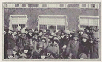 A large group of students outdoors with the visitor