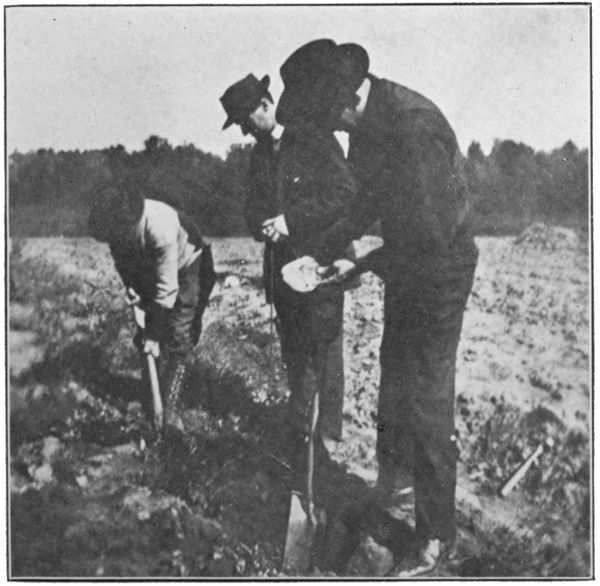 Members digging at site