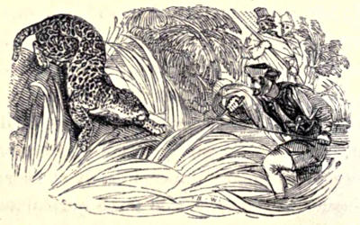 Man with a spear facing down a jaguar
